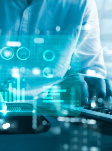 business chart and graph. Businessman using computer laptop and smart phone virtual hologram. business technology concept